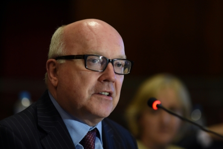 George Brandis says the government will adopt the proposed changes to anti-terror laws that criminalise disclosure.[ AAP/Lukas Coch] Australian Attorney-General George Brandis addresses the Law, Crime and Community Safety Council meeting at old Parliament House in Canberra, Thursday, Nov. 5, 2015. 